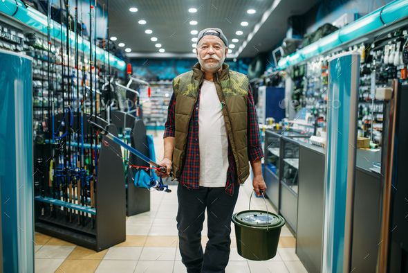 Fisherman with rod and bucket in fishing shop