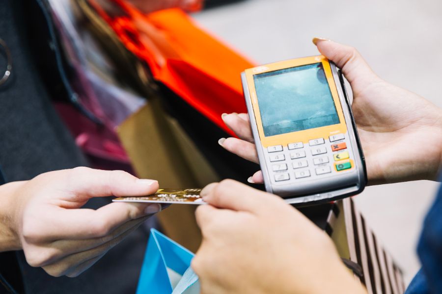 cash and card payment with chip and pin machine in shop